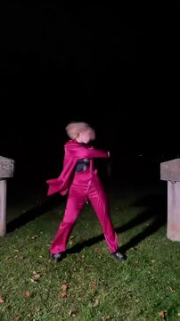 Professional dancer performing waacking at night