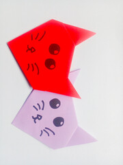 Origami red and purple cat head isolated on white background.