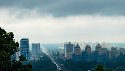 Obraz premium View of Kyiv under a dramatic overcast sky showcasing modern architecture and city life
