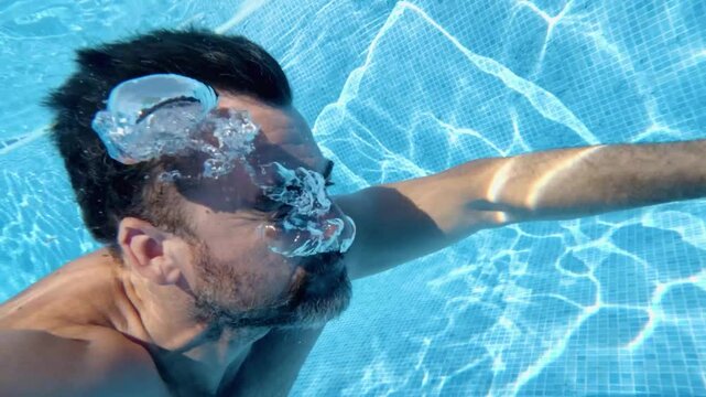 Bearded man swimming and holding breath underwater in blue pool, montage of different perspectives