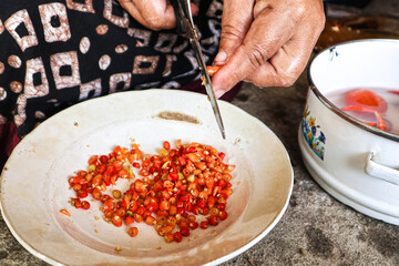 Woman Chopping Chili Peppers for Cooking. Sambal dabu-dabu