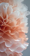 Close-up of a layered paper flower ball, peach and white