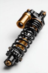 Close-up of a black motorcycle shock absorber with gold accents