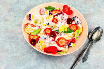 Fruit salad decorated with flowers.