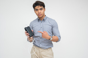Young Asian man promoting power bank seriously