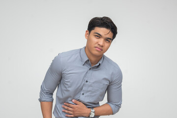 Young Asian man experiencing stomach pain