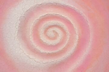 Aerial View of Pink Spiral Pattern in Salt Flats with Cracked Earth Texture