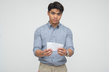Asian man holding envelope with serious face