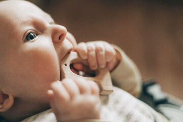Baby Chewing on Wooden Teething Toy Close-Up