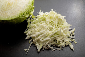 Fresh green cabbage cut into strips on a black background.
Fresh ripe cabbage. Shredded cabbage....