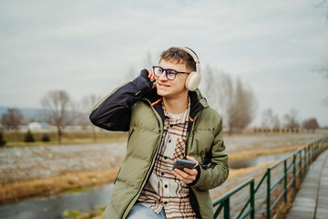 Young adult caucasian student smile and using smart phone to talk or take self portrait