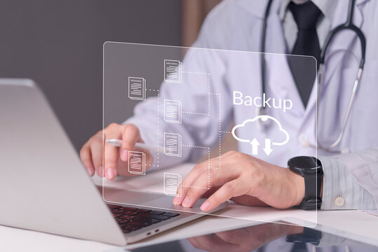 Physician working on laptop with virtual screen displaying cloud backup icon, concept medical data protection, electronic health records, cybersecurity healthcare, future healthcare solutions.