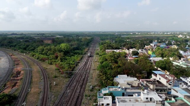 Aerial drone shot of railway tracks splitting into the city in India