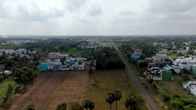 Endless green fields, water bodies, and rural homes viewed from above