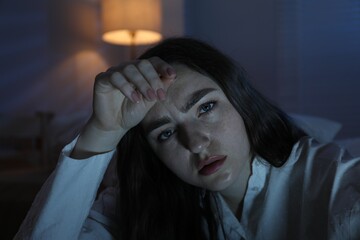 Frustrated woman suffering from insomnia at home