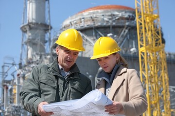 Engineers reviewing blueprints at a construction site