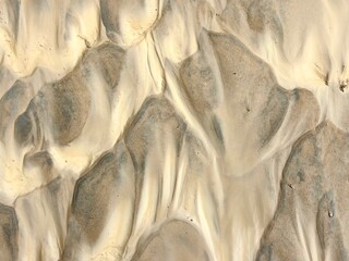 textured formations sand and clay reveal intricate patterns shaped by natural forces at shore....