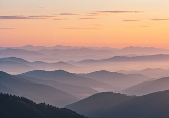 Obraz premium Misty Layered Mountain Range at Dawn with Soft Pastel Sunrise Light