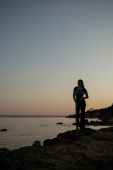 Fototapeta premium A person standing in front of a body of water