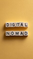 Obraz premium Wooden blocks spelling out digital nomad on a yellow background represent the growing trend of location independent remote work and the work and travel lifestyle