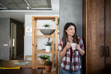 Woman drinking coffee and enjoying a quiet moment at home