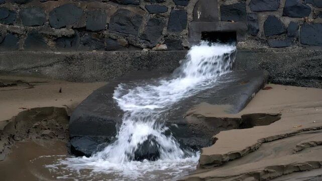 Water Emerging from Sewage Pipe During Stormy Weather