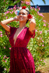 Beautiful young woman wearing flower crown, enjoying sunny day outdoors