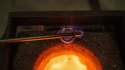 Metal ring being forged in molten furnace flames - Powered by Adobe