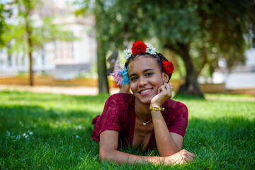 Beautiful young woman wearing flower crown, enjoying sunny day outdoors