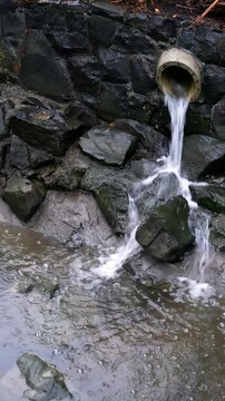 Water Emerging from Sewage Pipe During Stormy Weather