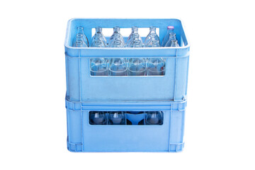 Glass clear bottles in plastic crate blue. Drinking water wait for distribute to grocery. Packaging...