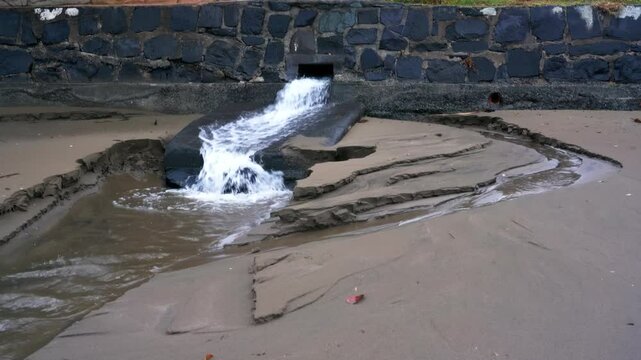 Water Emerging from Sewage Pipe During Stormy Weather