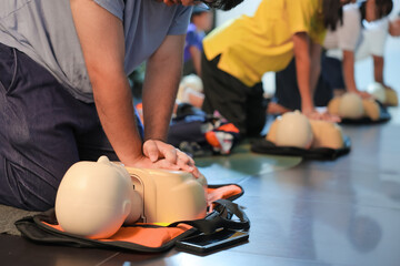 A person performs CPR chest compressions on a during a training session, highlighting essential...