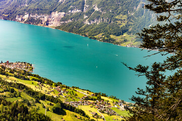 View of Lake Walen, Switzerland, Swiss Alps, Canton St. Gallen. Trees, meadows small villages in...