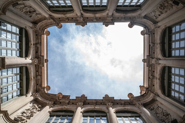 Looking up from a classic and luxurious building courtyard.