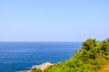 View over beach bay and green hills, Corsica, 13 June 2025
