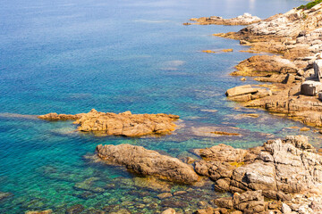 Coastal cliff with Mediterranean vegetation and blue sea, Corsica, 13 June 2025