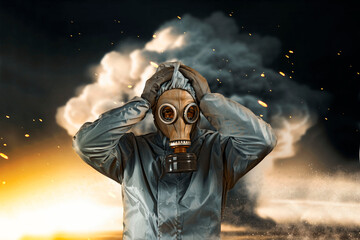 A man in a gas mask and protective suit clutching his head in panic. Nuclear explosion concept....