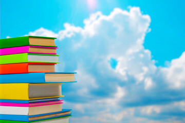 Books in multi-colored covers against the sky. Literature for children. Collection in the library....