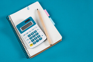 Calculator, notepad with bookmarks and stickers. The concept of diligent study of mathematics,...