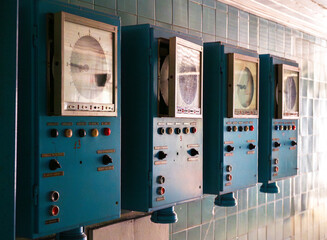 Vintage measurement devices mounted on a wall in an abandoned location showcasing retro technology...