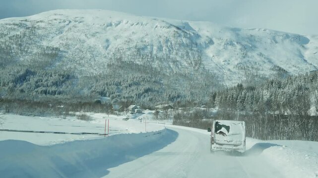 POV shot of a vehicle driving on a remote ice road with a shaky camera effect, capturing the rough, bumpy terrain and cold, desolate landscape. Winter adventure. High quality 4k footage