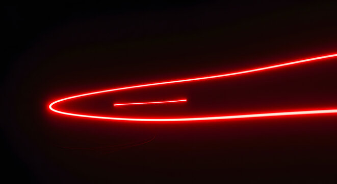 Luminous Trail of Red Light: A mesmerizing streak of red light dances across the black canvas, drawing the eye with its futuristic glow.