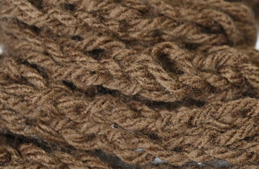 Macro close-up of brown cable knit wool textile with intricate fibers