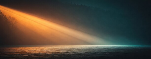A dramatic light beam over water with a dark sky creating a moody and atmospheric landscape view