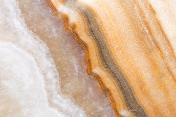 Natural onyx marble texture featuring layered beige, brown, and golden tones, perfect for interior design, tiles, and luxury backgrounds.
