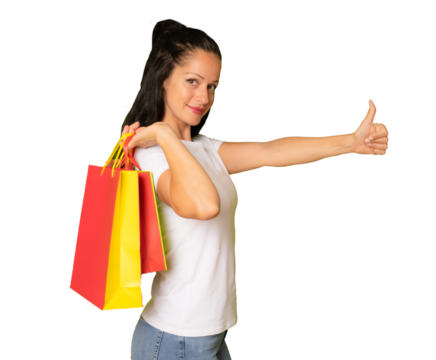 Young woman holding shopping bags with thumb up, isolated on transparent background. PNG background.