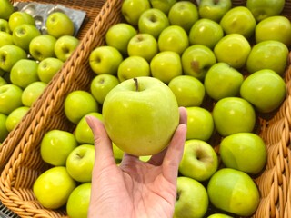 Hand women hold some apple at market