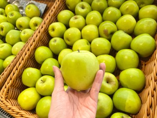 Women pick some apple at market