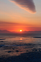 Gentle Sunrise Over a Partially Frozen Sea
